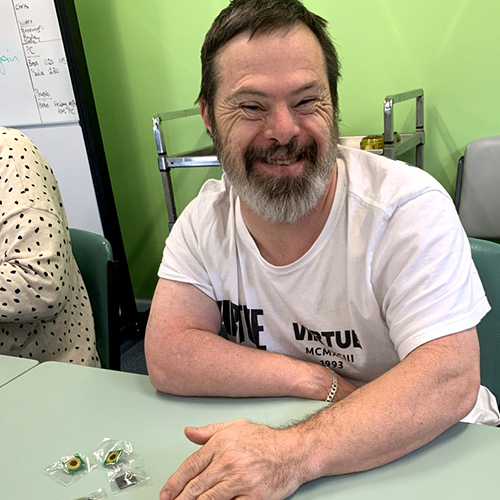 Image of smiling man with a green background